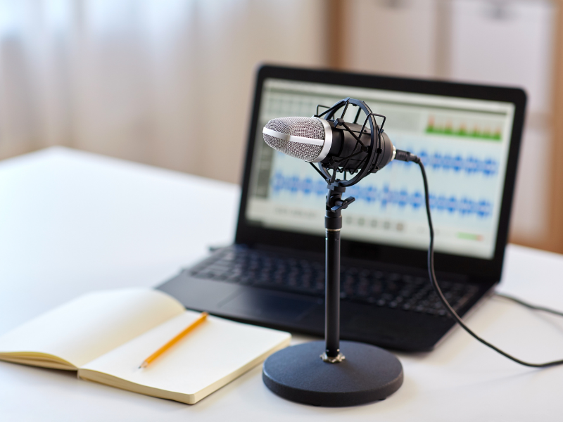 Illustration of podcaster with notes and mic